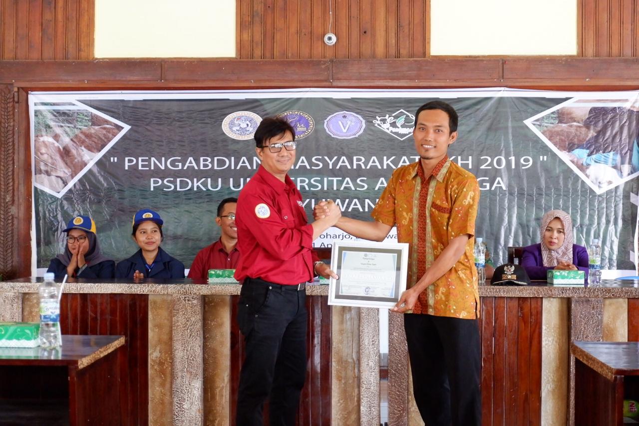 Representative of FKH PSDKU Universitas Airlangga Banyuwangi presents a token of appreciation to the local authorities.